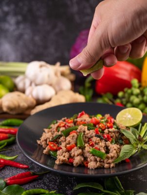 stir-fried-pork-basil-on-banana-leaves-in-a-black-2025-01-16-13-59-15-utc.jpg